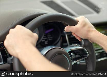 road trip, transport and people concept - close up of male hands driving car and holding wheel