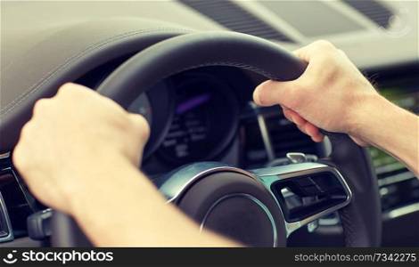 road trip, transport and people concept - close up of male hands driving car and holding wheel. close up of male hands driving car