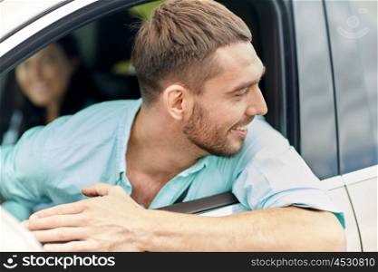 road trip, transport, travel and people concept - happy smiling man driving in car