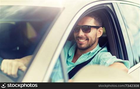 road trip, transport, travel and people concept - happy smiling man in sunglasses driving car. happy smiling man in sunglasses driving car