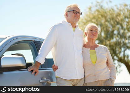 road trip, travel and old people concept - happy senior couple hugging at car in summer. happy senior couple hugging at car in summer