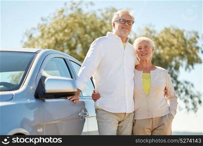road trip, travel and old people concept - happy senior couple hugging at car in summer. happy senior couple hugging at car in summer