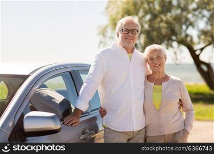 road trip, travel and old people concept - happy senior couple with car in summer. happy senior couple with car in summer