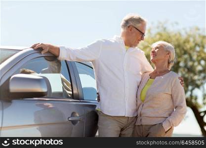 road trip, travel and old people concept - happy senior couple with car in summer. happy senior couple with car in summer