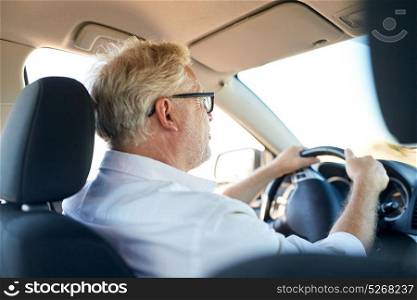 road trip, travel and old people concept - happy senior man in glasses driving car. happy senior man driving car