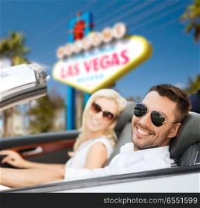 road trip, travel and people concept - happy couple driving in convertible car over welcome to fabulous las vegas sign background. couple driving in convertible car at las vegas. couple driving in convertible car at las vegas