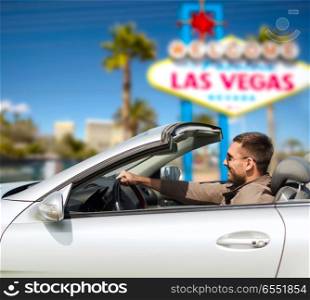 road trip, travel and people concept - happy man driving convertible car over welcome to fabulous las vegas sign background. happy man driving convertible car at las vegas. happy man driving convertible car at las vegas