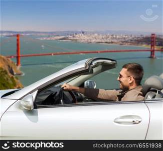 road trip, travel and people concept - happy man driving convertible car over golden gate bridge in san francisco bay background. happy man driving convertible car. happy man driving convertible car