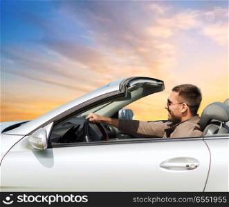 road trip, travel and people concept - happy man driving convertible car over sky background. happy man driving convertible car over sky. happy man driving convertible car over sky
