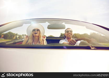 road trip, travel, dating, couple and people concept - happy man and woman driving in cabriolet car outdoors