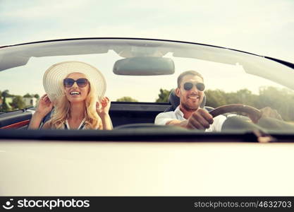 road trip, travel, dating, couple and people concept - happy man and woman driving in cabriolet car outdoors