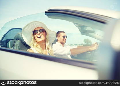 road trip, travel, dating, couple and people concept - happy man and woman driving in cabriolet car outdoors