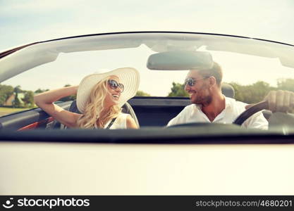 road trip, travel, dating, couple and people concept - happy man and woman driving in cabriolet car outdoors