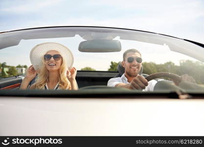 road trip, travel, dating, couple and people concept - happy man and woman driving in cabriolet car outdoors