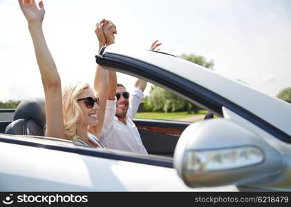 road trip, travel, dating, couple and people concept - happy man and woman driving in cabriolet car outdoors