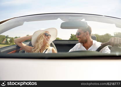 road trip, travel, dating, couple and people concept - happy man and woman driving in cabriolet car outdoors