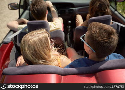 road trip, travel, vacation and people concept - happy friends driving in convertible car at summer