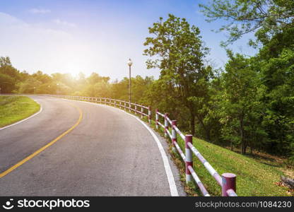 road view reservoir green tree with green nature forest in the hill and blue sky background.