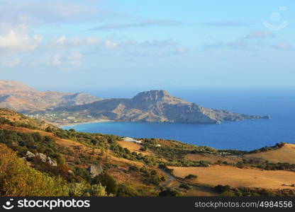 road winds among mountains to sea