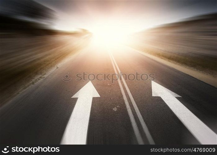 Road with arrow. Conceptual image of asphalt road and direction arrow
