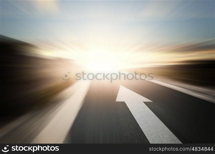 Road with arrow. Conceptual image of asphalt road and direction arrow