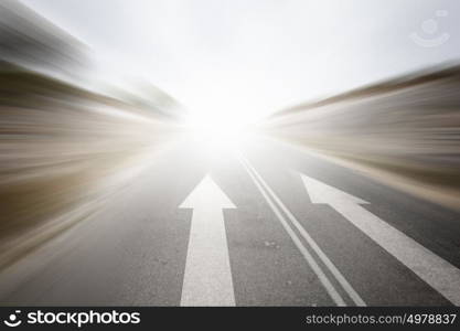 Road with arrow. Conceptual image of asphalt road and direction arrow