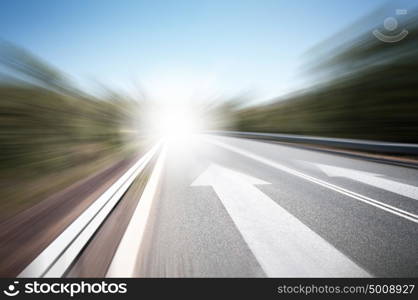 Road with arrow. Conceptual image of asphalt road and direction arrow