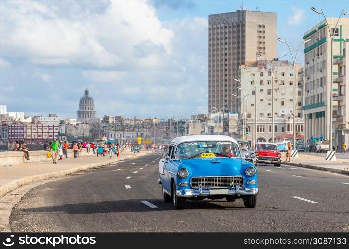 Road with old retro cars along Malecon street, in the center of Havana, Cuba