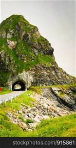 Road with old tunnel in green summer mountains, Norway. National tourist Andoya route.. Road with old tunnel in mountains Norway