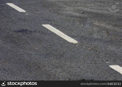 Road with white lines and asphalt texture - Focus on the center of the image -