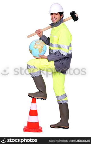 road worker holding a hammer on his shoulder and a globe