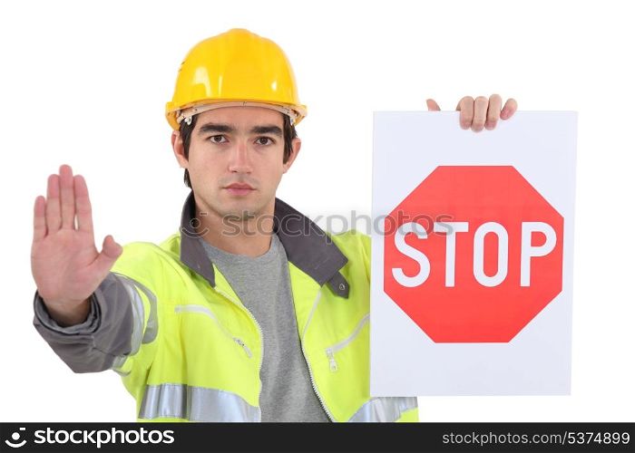 road worker holding a stop sign