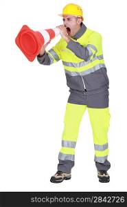 road worker shouting through a traffic cone