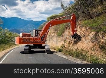 Road works. Excavator repair the road.