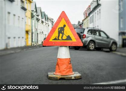 Roadwork sign on a cone at a street