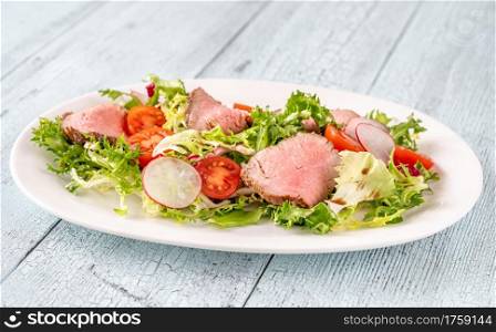 Roast beef salad on the serving plate