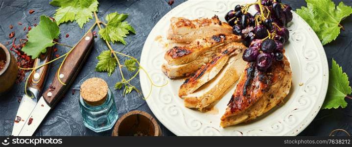 Roast chicken breast with grapes.Summer BBQ.Barbecued chicken meat.. Grilled chicken fillets