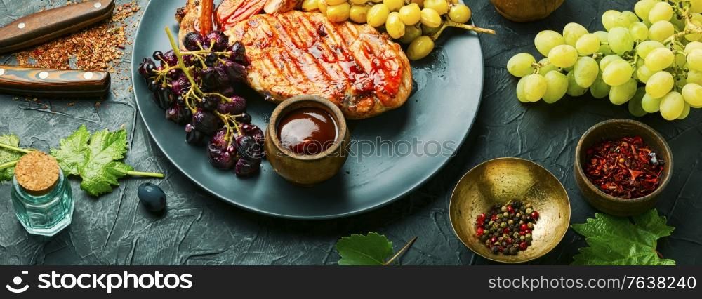 Roast chicken breast with grapes.Summer BBQ.Barbecued chicken meat.. Sliced grilled chicken breast
