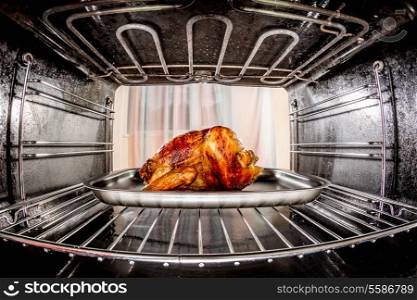 Roast chicken in the oven, view from the inside of the oven. Cooking in the oven.