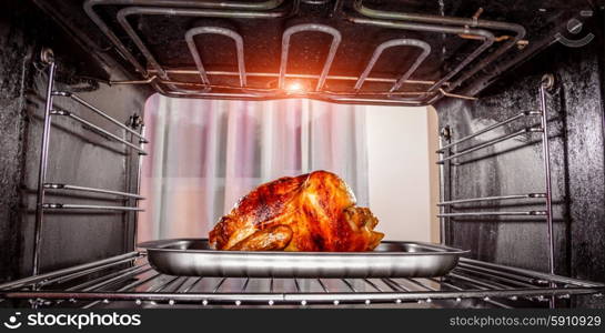 Roast chicken in the oven, view from the inside of the oven. Cooking in the oven. Thanksgiving Day.