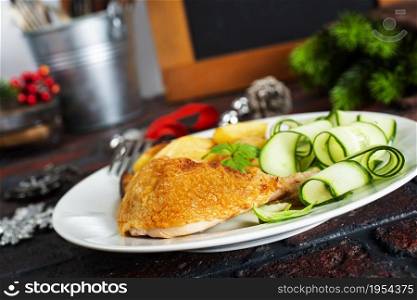 Roast chicken on a plate. Christmas background