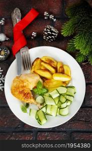 Roast chicken on a plate. Christmas background