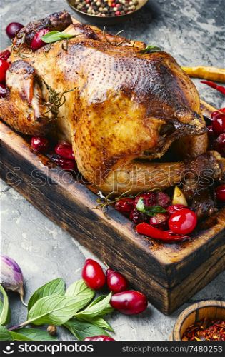 Roast chicken on cutting board with dogwood.Baked chicken in berry sauce. Baked chicken in berry sauce