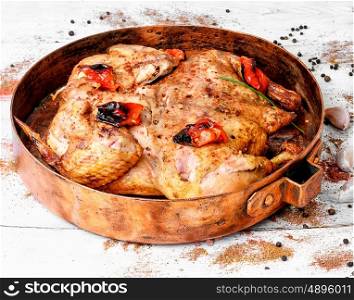 roast chicken tobacco on copper pan. grilled chicken cooked in pan with spices according to the Georgian recipe