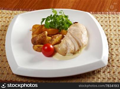 Roast chicken with potatoes. Shallow depth-of-field