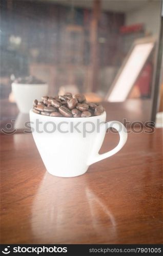 Roast coffee bean in white mug, stock photo