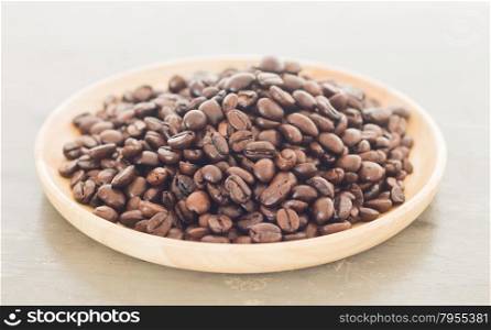 Roast coffee bean on wooden plate, stock photo