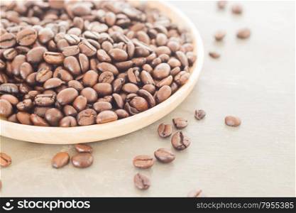 Roast coffee bean on wooden plate, stock photo