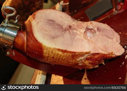 Roast Cured Pork inside Black Metallic Slicing Equipment