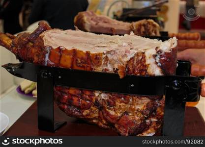 Roast Cured Pork inside Black Metallic Slicing Equipment